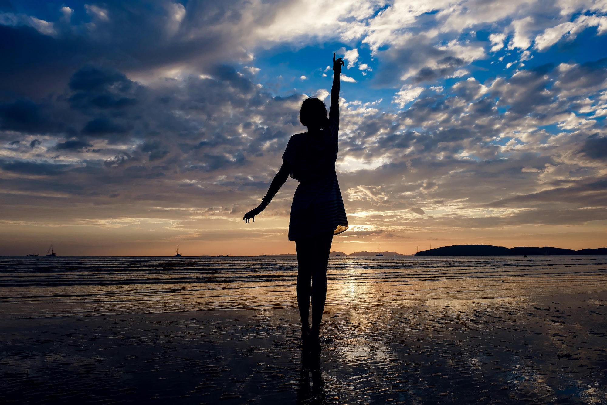 Happy Carefree Woman Enjoying Beautiful Sunset on the Beach